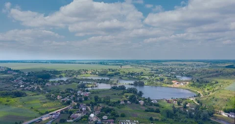 Clouds fly fast over a winding Amazing  lake and green forests on a sunny summer Stock Footage 112701440