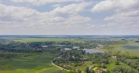 Clouds fly fast over a winding Amazing  lake and green forests on a sunny summer Stock Footage 112704052