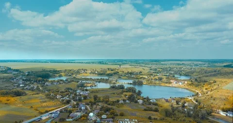 Clouds fly fast over a winding Amazing  lake and green forests on a sunny summer Stock Footage 112710303