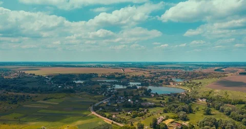 Clouds fly fast over a winding Amazing  lake and green forests on a sunny summer Stock Footage 112718673