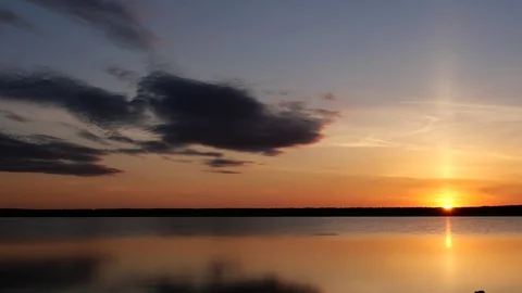 Clouds fly over glassy water surface, golden river sunset, time lapse Stock Footage 91069577