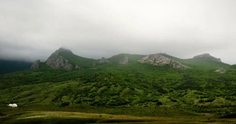 Clouds fly over mountain peaks Stock Footage 76425453