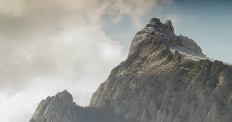 Clouds fly over a rock covered with snow Stock Footage 79383610