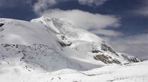 Clouds fly over snowy mountain peak Video stock 67646072