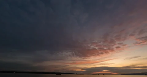 Clouds fly on the sky, the silhouette of ships and mountains on a summer evening Stock Footage 137931085