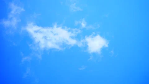 Clouds fly through a bright blue sky Stock Footage 131518277