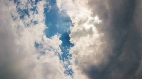 Clouds flying on blue sky dramatically with sun rays Stock Footage 765695