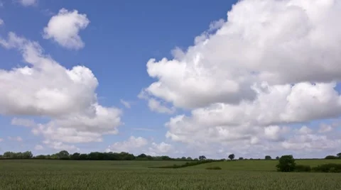 Clouds flying over rural farmland landscape Stock Footage