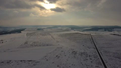Clouds flying over the sun in a winter day, everything is covered with snow Stock Footage 236291437