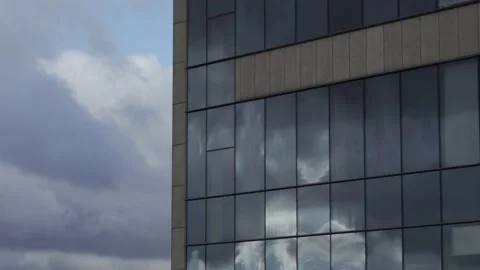 Clouds flying in real time reflecting in business center building Stock Footage 218602030