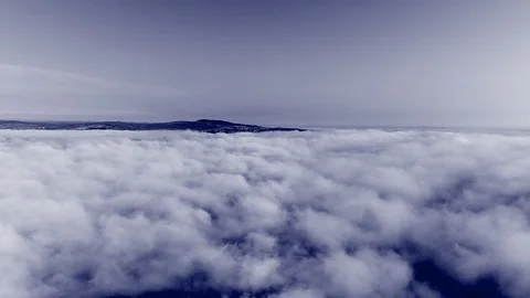 Clouds flying, rolling and morphing covering summer landscape with lights at Stock Footage 127173885