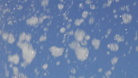 Clouds of foam fly against the blue sky Stock Footage 284714171