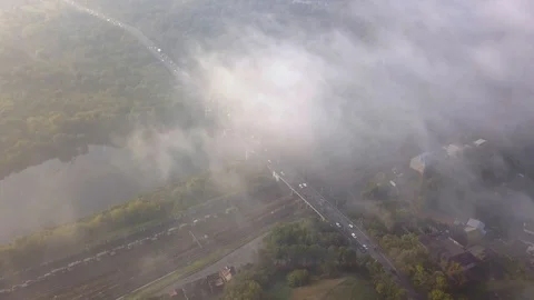 Clouds of fog fly over the road bridge across the river. Stock Footage 96238422