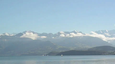 Clouds form around a snow covered mountain Video stock 32281212