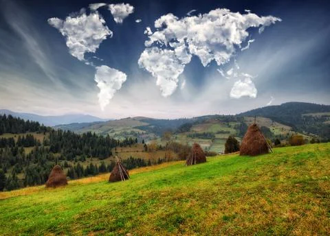 Clouds in the form of a map of the world over the mountains Stock Photos