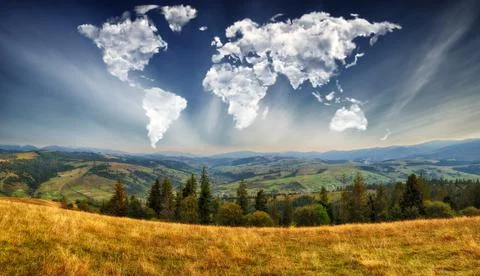 Clouds in the form of a map of the world over the mountains Stock Photos