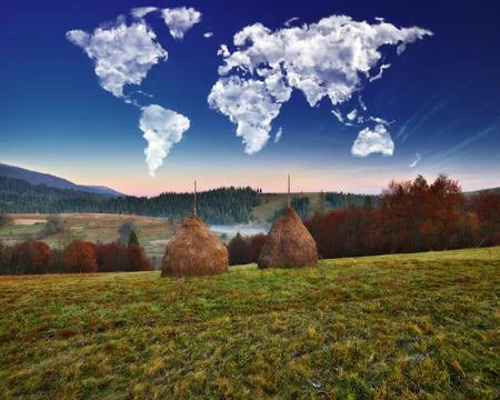 Clouds in the form of a map of the world over the mountains Stock Photos