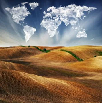 Clouds in the form of a map of the world over the field Stock Photos