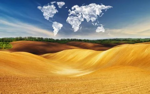 Clouds in the form of a map of the world over the field Stock Photos