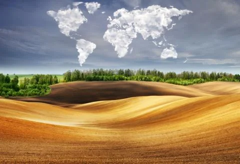 Clouds in the form of a map of the world over the field Stock Photos