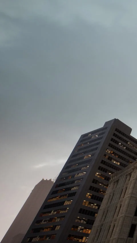 Clouds form over buildings in a city during dusk near evening time Stock Footage 340257877