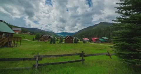Clouds form over mountains as camera slides across fence Stock Footage 65450205