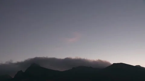 Clouds form over mountains during sunset Concept of nature's self-healing in tim Stock Footage 132167489