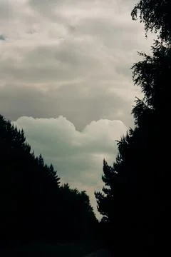Clouds form a shape resembling a heart Stock Photos