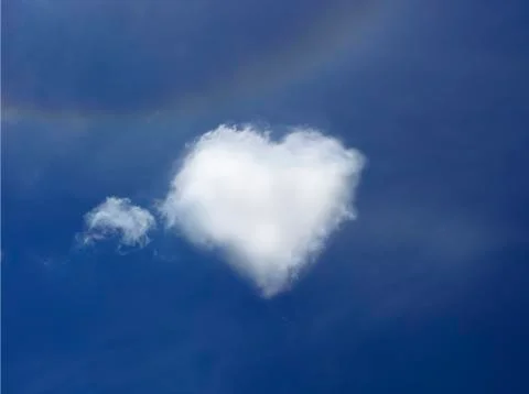 Clouds forming a heart shape with blue sky Stock Photos