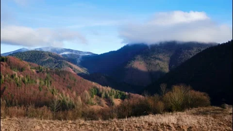 Clouds forming over the hills.Shadows advancing across the landscape at the end 動画素材 230719679