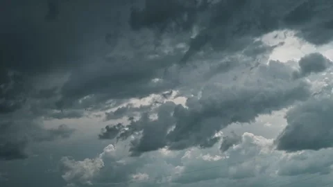 Clouds gather in the sky, showcasing shifting shapes and colors as a storm 스톡 동영상 339016495
