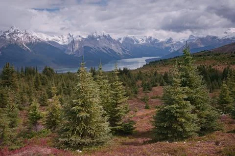 Clouds gathering above the mountain range in Canadian Rockies. Maligne lake in Stock Photos