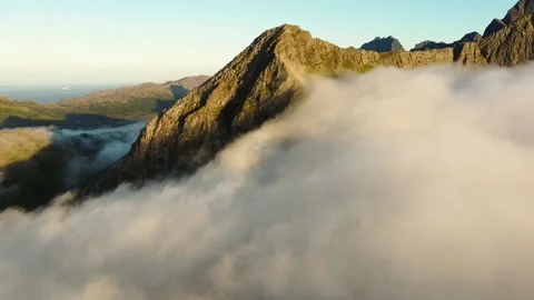 Clouds gently rolling over a mountain top Stock Footage 278749282