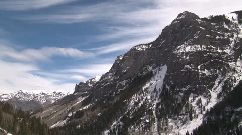 Clouds gently shift across the tips of rugged mountain peaks. Stock Footage 36641300