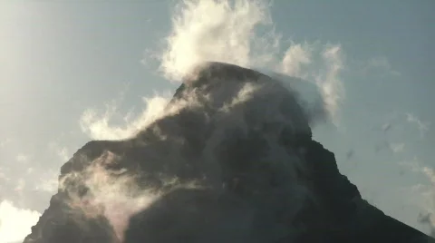 Clouds give steamy impression to mountain Stock Footage 776810