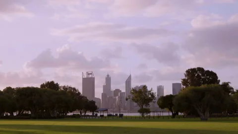 Clouds glide over Perth City viewed across river and park Stock Footage 158962791