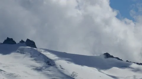 Clouds gliding over snowy mountain summit Stock Footage 66781540