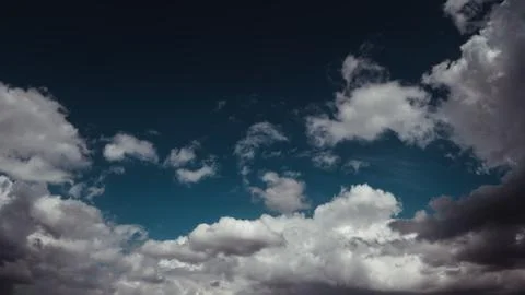 Clouds gliding through a dark sky Stock Photos