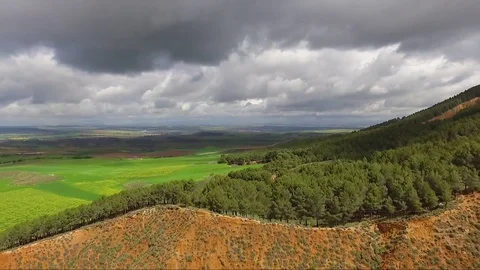 Clouds, green fields and red soil | Aerial Vídeos de archivo 82268453