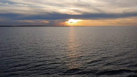 Clouds hide evening sun reflecting in deep calm river Stock Footage 113188139