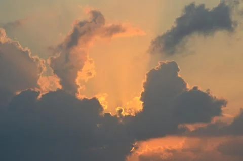 Clouds hiding the rising sun. Stock Photos