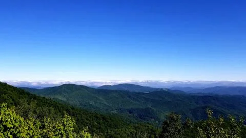 Clouds on Horizon Bordering High Mountain Vista 1 Stock Photos