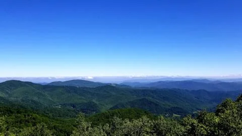 Clouds on Horizon Bordering High Mountain Vista 4 Stock Photos