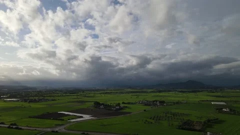 Clouds hung in the interim over the green fields. Stock Footage 236502727