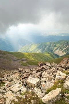 The clouds hung low over rocky slopes in the central asian mountains. Amazing Stock Photos