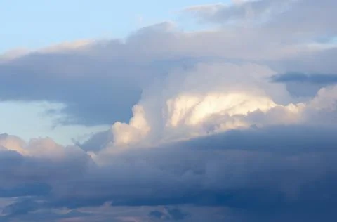 Clouds illuminated by the evening sun Stock Photos