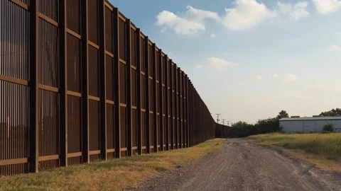Clouds Jumping the Border Fence between the USA and Mexico Stock Footage