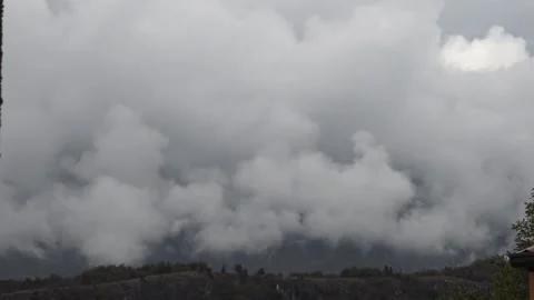 Clouds lifting and revealing a mountain Stock Footage 158761269