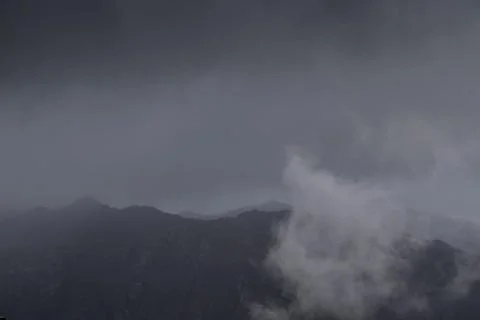 Clouds lifting up from the mountains Stock Photos