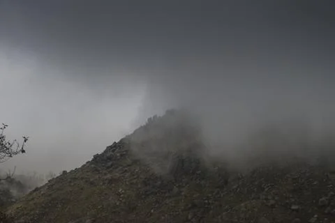 Clouds lifting up from the mountains Stock Photos